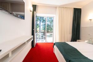 Postel nebo postele na pokoji v ubytování Hotel Cirus