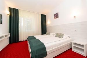 Postel nebo postele na pokoji v ubytování Hotel Cirus
