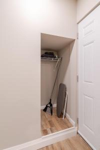 a door into a closet with a vacuum at ENTIRE 1 BEDROOM APARTMENT ACROSS FROM GOOGLE - br1 in Kitchener