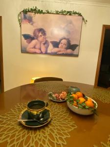 a table with a bowl of fruit and a plate of cherries at Casa Ivy in Serra Rocco +14 photos