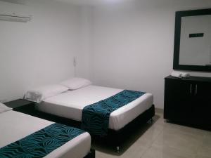 Hotel Septima Avenida tesisinde bir odada yatak veya yataklar