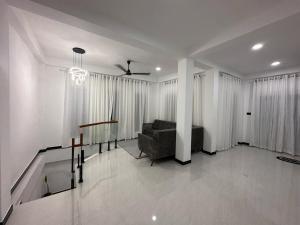 a living room with a couch and a table at Kyali Homestay Tangalle in Tangalle