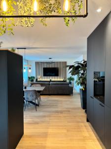 a living room with a couch and a table at Römer Apartment in Kaiseraugst