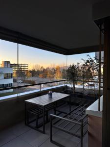 a table and chairs on a balcony with a view at Römer Apartment in Kaiseraugst