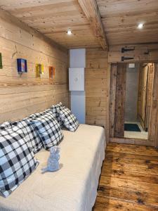 un osito de peluche sentado en una cama en una cabaña en Mazot du Criou - Samoëns, en Samoëns