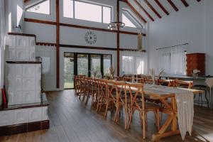 a dining room with a long table and chairs at Chalet Odette in Pangarati