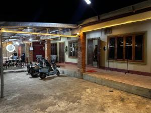 a couple of motorcycles parked outside of a building at Happy Hotel in Vang Vieng