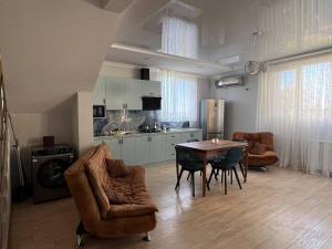 a kitchen and dining room with a table and chairs at GT House Batumi in Batumi