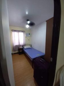 a small bedroom with a blue bed in a room at Jb Place Hernan in Cebu City +11 photos