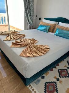 a large bed with towels on it in a room at Riad Ras Lafaa in Safi
