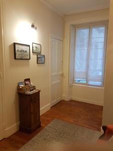 an empty living room with a window and a table at coeur de ville in Vannes +2 photos