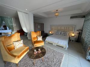 a bedroom with a bed and a couch and a table at Riad Ras Lafaa in Safi