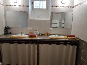 a bathroom with three sinks and a large mirror at coeur de ville in Vannes