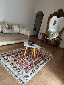 a living room with a couch and a table at Riad Ras Lafaa in Safi