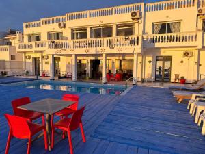 a patio with a table and chairs next to a building at Riad Ras Lafaa in Safi