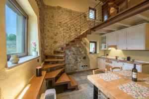a kitchen with a wooden staircase in a house at Fontanassa ss in Gavi +19 photos