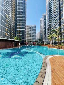 a large swimming pool in a city with tall buildings at Tâm an house in Gò Công