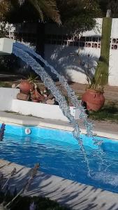 a water hose coming out of a swimming pool at Casa y cabaña de Gachy in Villa Carlos Paz