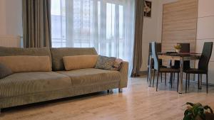 a living room with a couch and a table at Apartament na Kruczej in Lubin