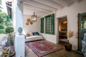 a living room with a couch and a table at L'Hacienda Occitane in Nègrepelisse