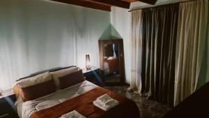 a bedroom with a bed and a room with a window at hena apart 1 in Esquel