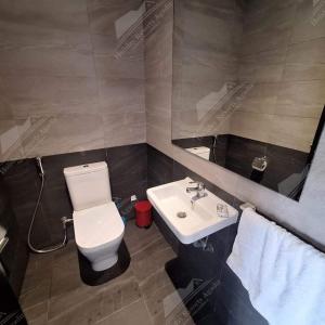 a bathroom with a white toilet and a sink at Beach Side Bliss Taghazout Bay Taounza in Taghazout +31 photos