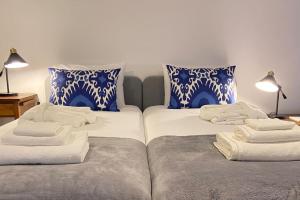 two beds sitting next to each other with towels on them at CHC Rochinha Studio in Funchal +24 photos