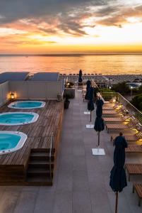 a rooftop deck with hot tubs on a cruise ship at Hotel Cristallo in Giulianova