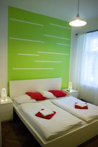 a bedroom with a bed with red pillows on it at Budget Apartment in Prague