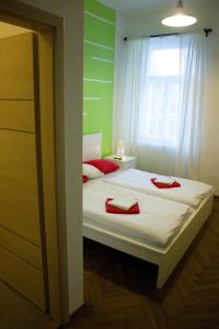 a bedroom with a bed with red towels on it at Budget Apartment in Prague