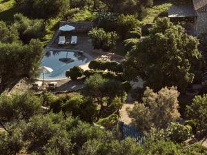 an overhead view of a house with a swimming pool and trees at Strofilia Stone Residences in Volímai +30 photos