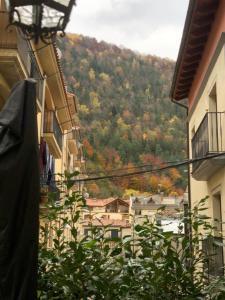 a view of a town from between two buildings at Maison Biscuit. Apartament a la plaça de la vila in Camprodon