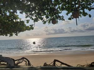 a view of the beach with a person in the water at Pousada Odoyá Beach - Quádrupla in Conde