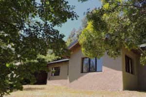 a house with trees in front of it at Casa Arrayán in San Carlos de Bariloche