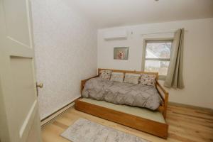a bedroom with a bed and a window at Walk to Cafe & Mall, One Mile to Dordt, Dog Theme in Sioux Center