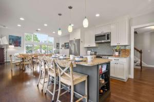 a large kitchen with a table and chairs in it at Oasis near beach Pool large yard and airy kitchen in Orleans +23 photos