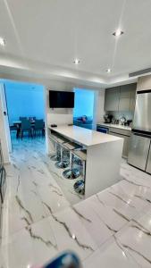 a white kitchen with a table and a dining room at The Happy Place in San Juan