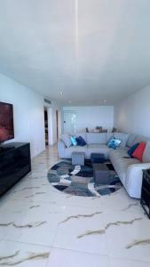 a living room with a couch and a tv at The Happy Place in San Juan
