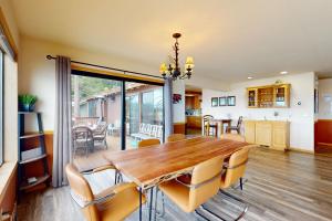 a dining room and kitchen with a wooden table and chairs at Cascade Charms in South Lake Tahoe