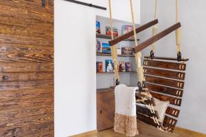 a room with wooden walls and a staircase with a towel at Big 75m2 next to Opera building in direct centrum, Air-conditioned, balcony, 24h self checking in Banská Bystrica