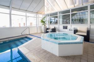 a large pool with a hot tub in a building at The Monterey Hotel, BW Signature Collection in Saint Helier Jersey +39 photos