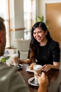 a woman sitting at a table with a plate of food at The Monterey Hotel, BW Signature Collection in Saint Helier Jersey