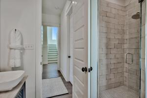 un bagno con doccia e lavandino di Gilligan's Island a Inlet Beach