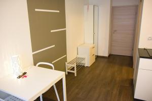 a room with a table and a chair and a door at Budget Apartment in Prague