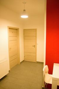 an empty room with a door and a table and chair at Budget Apartment in Prague