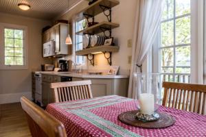 a kitchen with a table with a candle on it at Belize Carriage House in Rosemary Beach