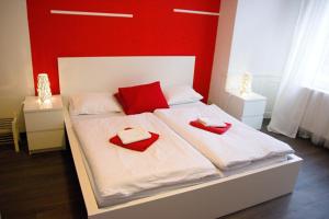a bedroom with two red pillows on a bed at Budget Apartment in Prague
