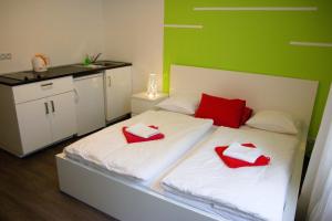 a bedroom with a bed with red pillows on it at Budget Apartment in Prague