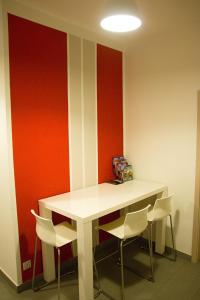 a dining room with a white table and chairs at Budget Apartment in Prague