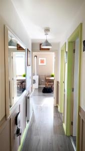 a hallway with green and white walls and wooden floors at Sidemersey Livings - Central and Quiet 2-Bedroom Apartment in Liverpool